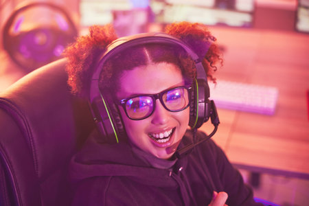 Happy streamer portrait, video game and girl with headphones in home of esports, online games or...