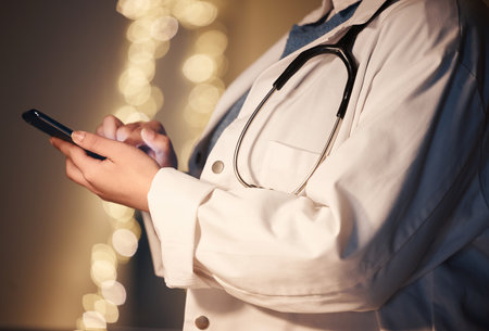 Hands, texting and night for doctor, woman and reading social media app, networking or news on web. Medic, smartphone or website for medical journal, newspaper or research on internet at hospital jobの写真素材