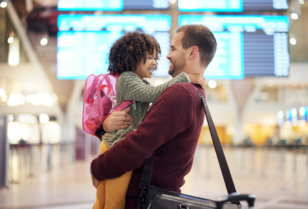 Father, travel and hug girl at airport, laughing at comic joke and having fun together. Immigration flight, adoption care and love of happy man hugging foster child at airline, smile and bonding.の写真素材