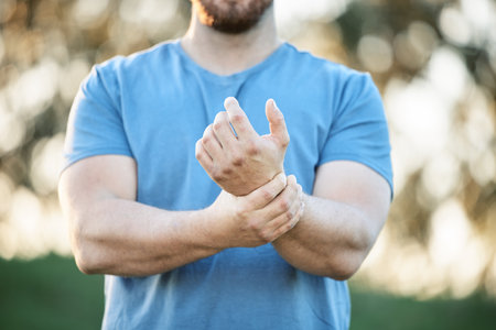 Injury, sports and man with wrist pain from a workout, exercise accident and sprain from cardio. Fitness, emergency and athlete with carpal tunnel syndrome, inflammation and injured arm from trainingの写真素材