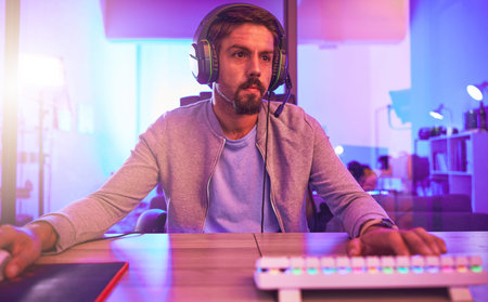 Computer video game, man and headphones for esports, online games or virtual competition in dark...