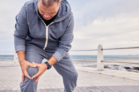 Knee injury, muscle and man exercise with medical pain, body emergency and sky mockup. Senior male, legs and fitness accident from workout, arthritis and anatomy of first aid, running risk and healthの写真素材