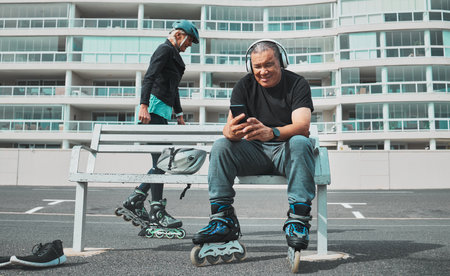 Roller skate, music and senior couple with phone in city for sports, adventure and fitness hobby outdoors. Retirement, holiday and elderly man and woman ready for skating, relaxing and journeyの写真素材