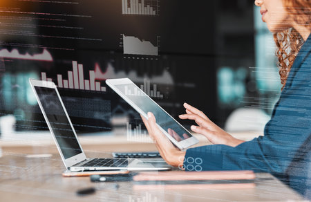Businesswoman, laptop and tablet in analytics, data planning or marketing strategy at office desk. Hands of female analyst in management on touchscreen or computer for corporate statistics on overlayの写真素材