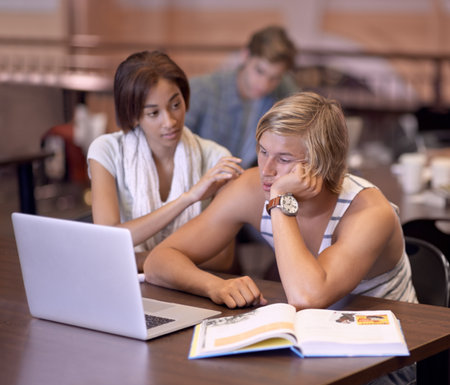 Dont worry, youve got this. Two students researching their assignments together on a laptop.の写真素材