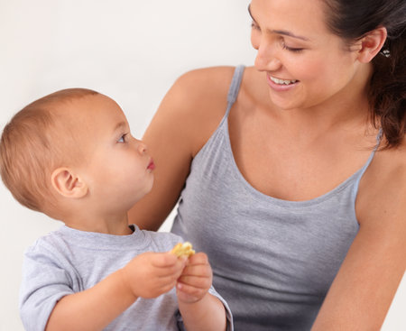 Just me and my baby. a beautiful young woman and her baby at home.の写真素材