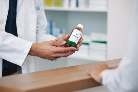 Doctor, hands and prescription medicine over the counter for consultation, healthcare or pharmaceutical product at clinic. Hand of pharmacist showing medical solution for healthy cure at pharmacyの写真素材