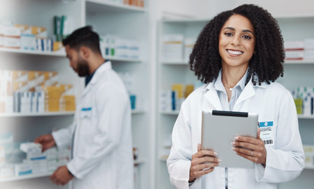 Smile, tablet and portrait of woman pharmacist with online checklist and happy to help with advice. Confidence, medicine and medical professional and healthcare consultant in wellness pharmacy.の写真素材