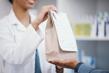 Pharmacy, product and pharmacist giving customer bag for pills prescription, medical supplements and medicine. Healthcare, dispensary and woman help man with medicare package, drugs and medicationの写真素材