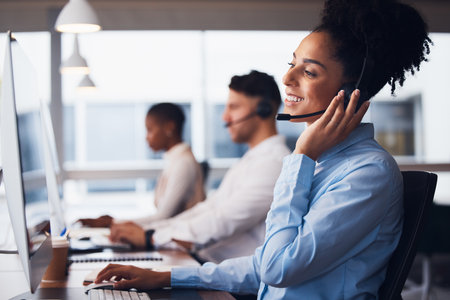 Call center, customer service and support with a black woman consultant working in her communication office. Contact us, telemarketing and consulting with a female employee at work using a headsetの写真素材