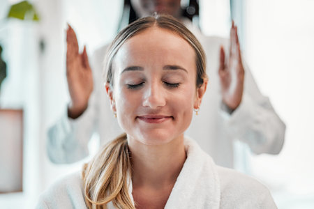 Relax, reiki and woman with smile on face at spa for spiritual chakra therapy and alternative medicine. Healing, balance and zen, person with peaceful mindset and healthy mind at traditional massage.の写真素材