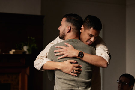 Friends, support group hug and men counseling for drug abuse and mental health problem. Empathy, psychology workshop and therapy session together in a circle for team building with care and helpの写真素材