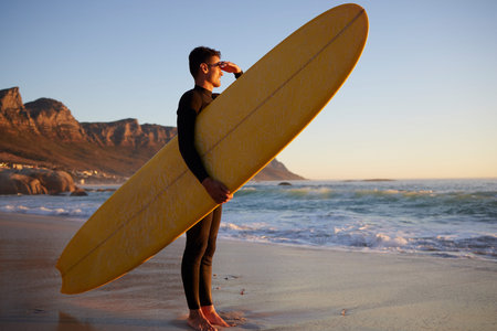 Surfer, man and beach with looking, waves and hand by eyes for safety from sun, thinking or planning...
