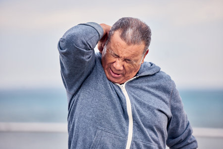 Fitness, outdoor and man with back pain, injury or accident while training for marathon or race....