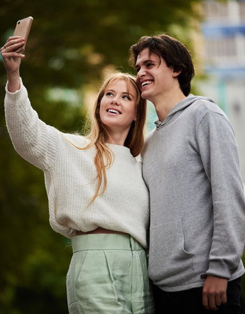 Selfie, happy and couple bonding in the city for memory, travel and on holiday together. Smile, date and woman taking a photo with a man on a vacation in an urban town for quality time and a breakの写真素材