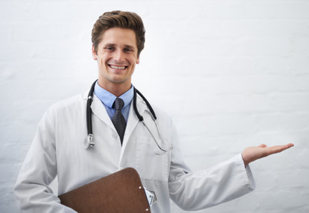 I think this will work for you. Portrait of a young doctor holding his hand up to copyspace.の写真素材