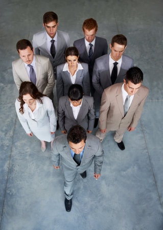 Driven and determined. Top view of a group of young businesspeople walking forward looking determined and serious.の写真素材