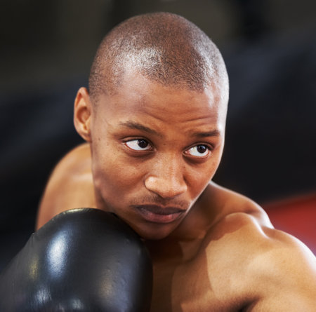 Resolved to be the best. A young boxer with determination and focus in his eyes.の写真素材