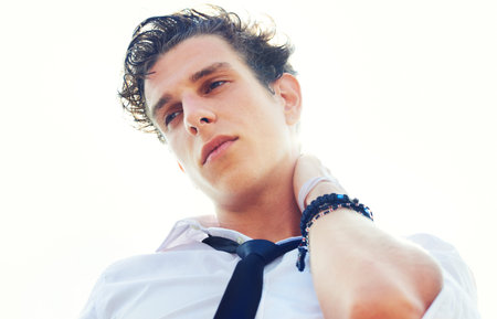 All this coolness is hard work. Low angle portrait of a handsome and stylish young man with his hand...