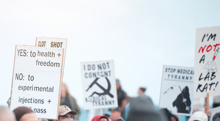 When a society stops weeping, they become enraged. Cape Town, South African - October 2, 2021 Unrecognisable demonstrators holding up signs and protesting against the Covid 19 vaccine.の写真素材