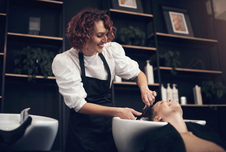 Do it with passion or not at all. a beautiful young woman getting her hair washed at the salon.の写真素材