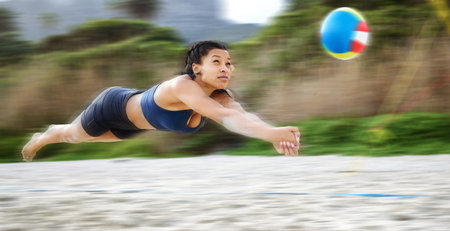 Beach volleyball, diving or sports girl playing a game in training or fitness workout in summer. Air jump, blurry dive action or active woman on sand in a fun competitive match in Sao Paulo, Brazilの写真素材