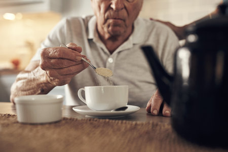 A warm cup of tea always does the trick. a senior man having a cup of coffee at home.の写真素材