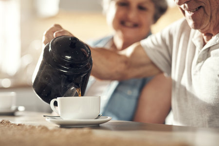Time for some tea. a senior couple having breakfast together at home.の写真素材