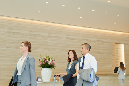 Business, corporate team in hotel and walking to international meeting, company workshop and coaching seminar. Employee trade show, management work conference and executive job teamwork collaborationの写真素材
