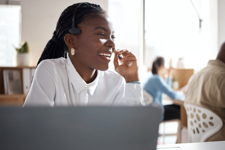 Customer satisfaction is what gets me out of bed. a young businesswoman using a headset and laptop...