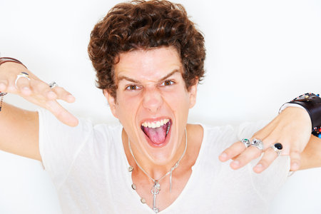Yeah. Studio portrait of a young man playing up for the camera isolated on white.の写真素材