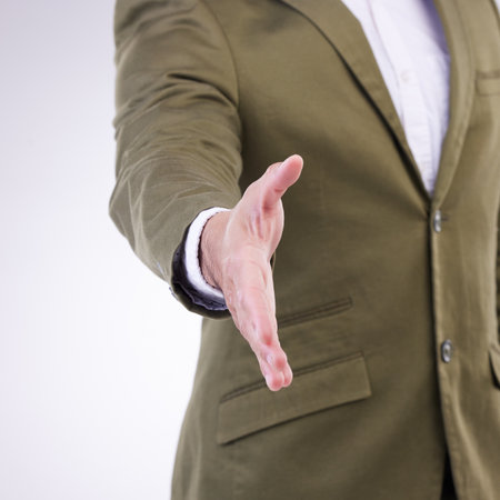 Hand, thank you and businessman handshake gesture for partnership isolated in a studio white background. Professional, employee and corporate person or worker with greeting offer to welcomeの写真素材