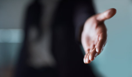 You need a helping hand. an unrecognizable businessman extending a handshake in an office.の写真素材