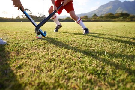 Taking his shot...Cropped image of children playing field hockey.の写真素材