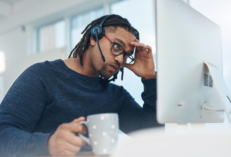 Have I hit a dead-end. a young businessman wearing a headset and looking stressed out while working...