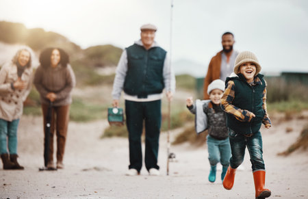 Running, happy and family at the beach for fishing, hobby and weekend activity. Carefree, freedom and children, parents and grandparents playing by the ocean and ready to catch fish for recreationの写真素材