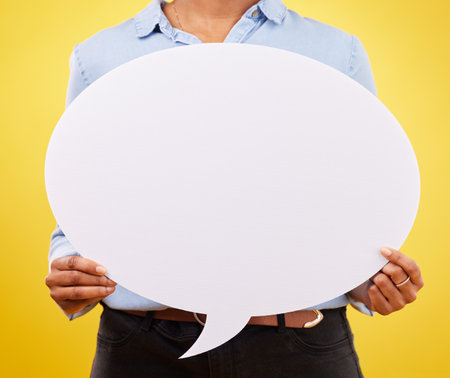 Social media, woman and hands with speech bubble for opinion, marketing space or brand advertising. Product placement info, mock up billboard or branding person with voice mockup on yellow backgroundの写真素材