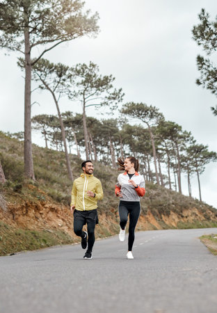 I wouldnt want to train with anyone else. Full length shot of two young athletes bonding together during a run outdoors.の写真素材