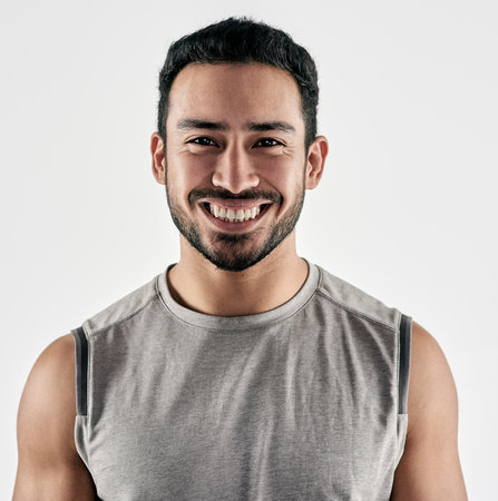 If something stands between you and your success, move it. Studio portrait of a sporty young man posing against a white background.の写真素材