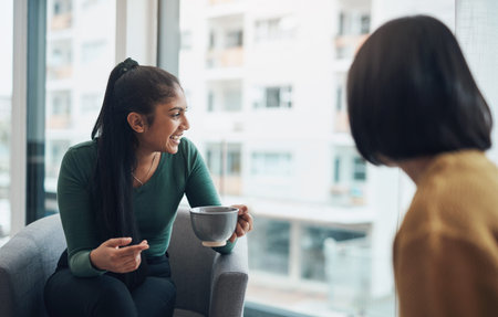 Enjoying good conversation and a good view. two young women drinking coffee while sitting together...