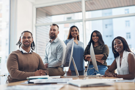 This is the team that can make it happen. Cropped portrait of a diverse group of businesspeople surrounding a boardroom desk during a meeting in the office.の写真素材