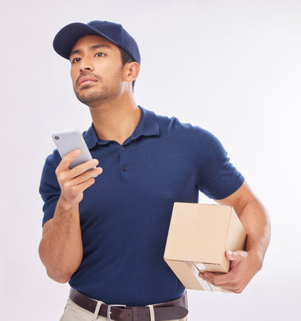 Delivery, ecommerce and courier with a phone using map to navigate with mobile app on the internet, web or website. Box, package and man worker holding shipment isolated in a studio white backgroundの写真素材