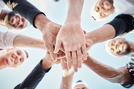 Hands, baseball motivation or sports men in huddle with support, hope or faith on field in fun game together. Teamwork, happy people or group of excited softball athletes with solidarity low angleの写真素材