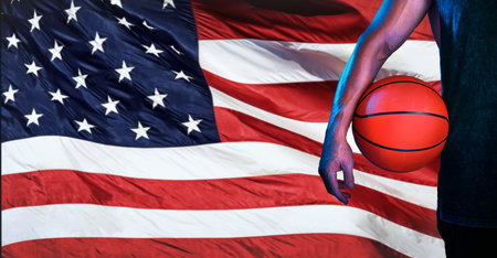 Sports, usa flag, and basketball with hand of man for fitness, training and competition match. Championship, games and muscle with athlete and ball with American pride for national, league and clubの写真素材