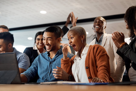 Good work brings great rewards. a group of young businesspeople using a laptop and looking shocked in a modern office.の写真素材