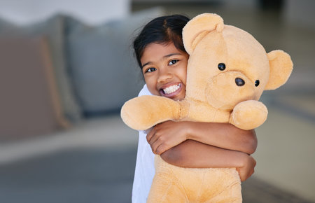 This is my best friend. a little girl holding her teddy bear.の写真素材