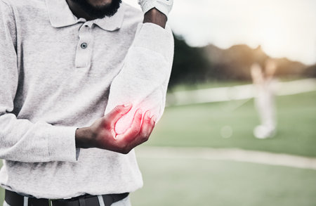 Sports, elbow pain and black man on golf course holding arm during game, massage and relief with health and wellness. Green, hands on injury for support and golfer with ache during golfing workout.の写真素材