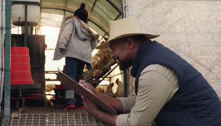 Cultivating a sustainable life for future generations to come. a man working on a chicken farm with...