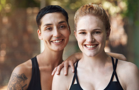 Were always up for a game. Cropped portrait of two attractive young female athletes standing together on the basketball court.の写真素材