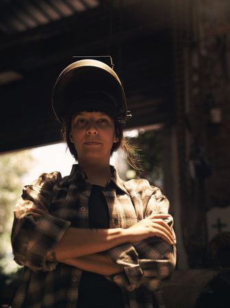 Its not a helmet, its my crown. Portrait of a confident young woman working at a foundry.の写真素材